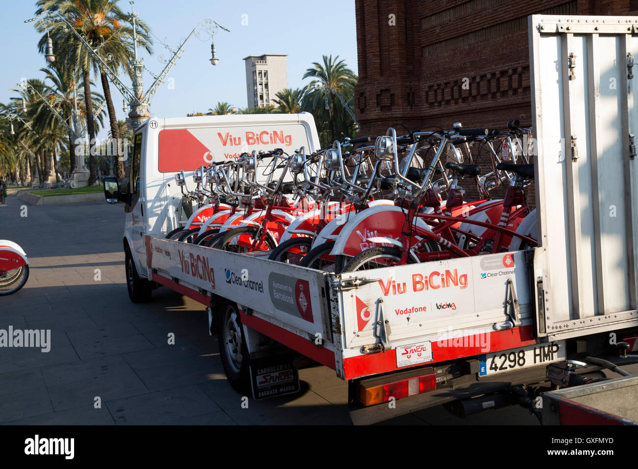 Red and white truck transporting bikes at the end of the day in Barcelona, Spain. Stock Photo