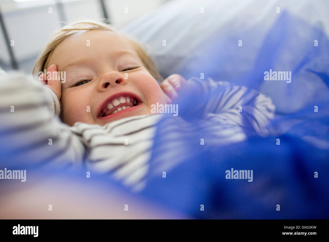 Laughing Caucasian baby girl wearing blue tutu Stock Photo