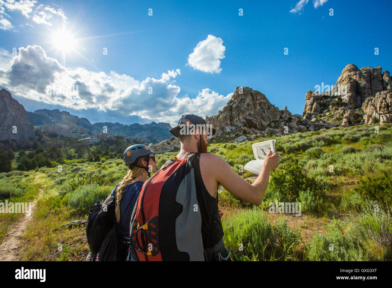 Caucasian couple reading guidebook near mountain Stock Photo - Alamy