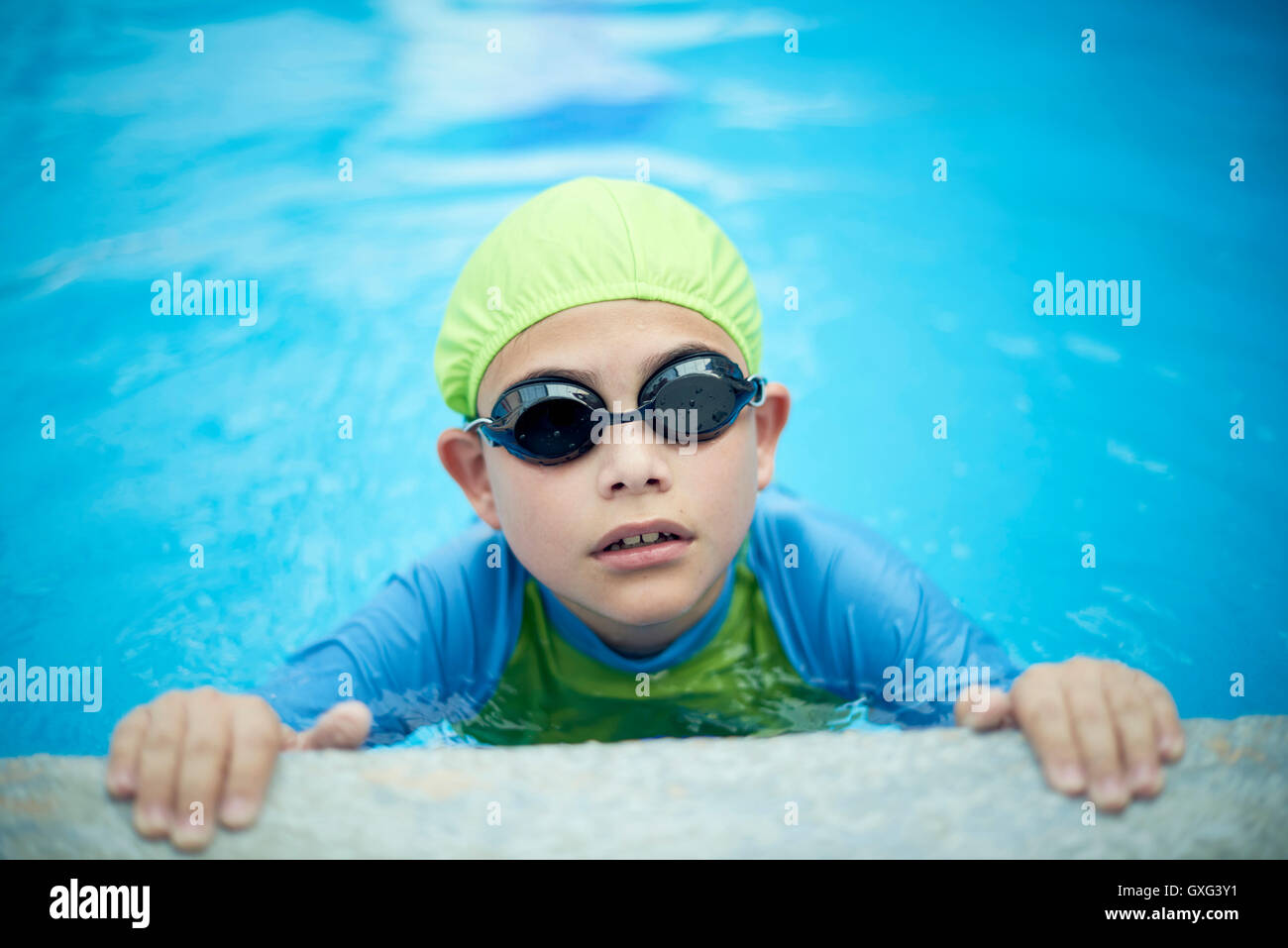 Hispanic boy swimming with swimming cap and goggles Stock Photo Alamy