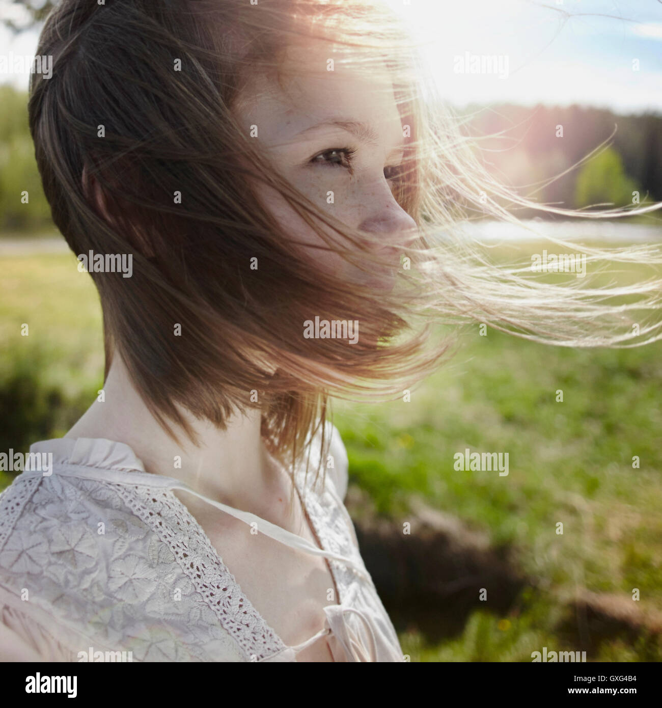 Caucasian girl with hair blowing in wind Stock Photo