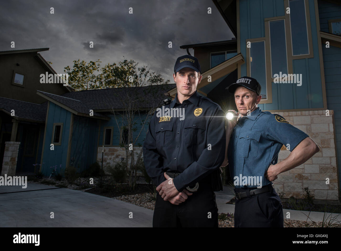 Caucasian security officers posing with flashlight Stock Photo