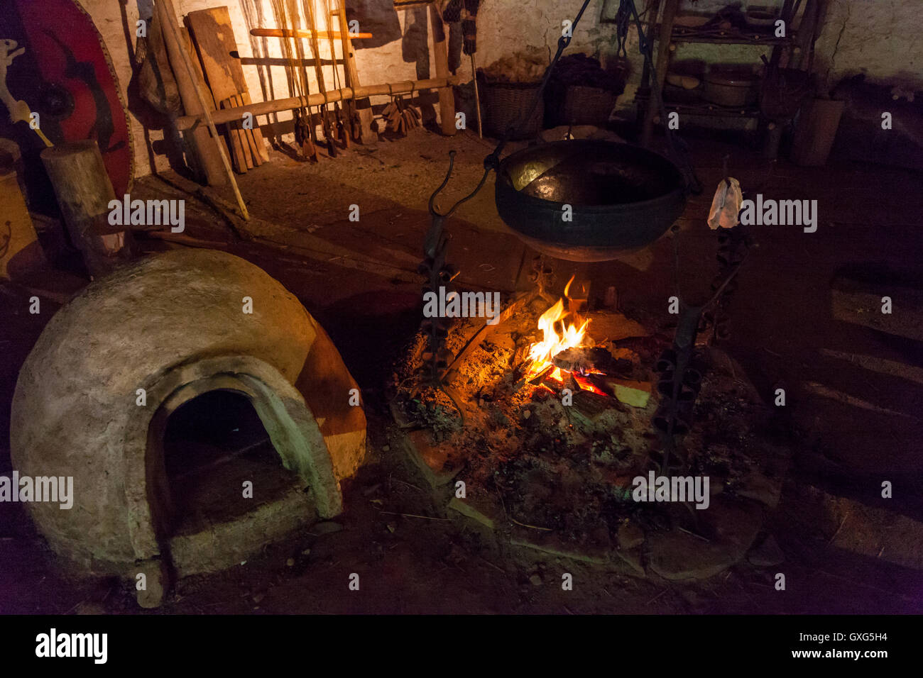 Wood fire at an iron Age hut recreation in St Fagans museum Cardiff, Wales Stock Photo