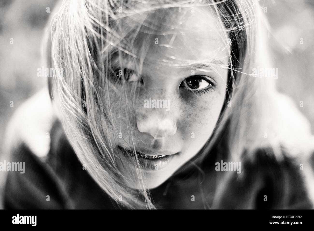 Hair of Caucasian girl with braces blowing in wind Stock Photo