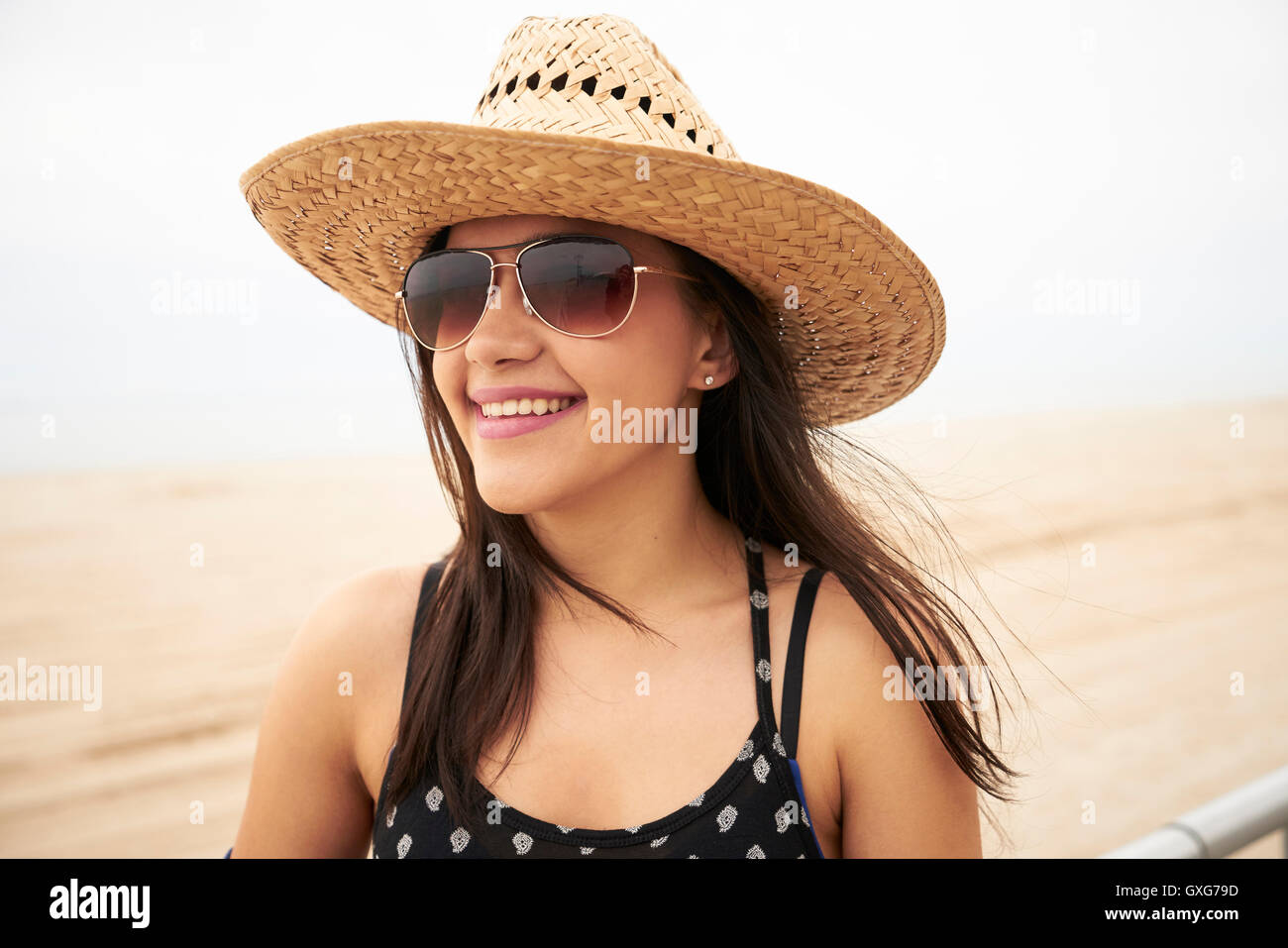 Mixed Race woman smiling on beach Stock Photo