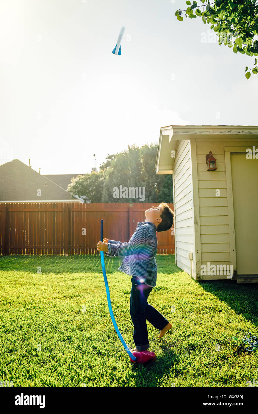Caucasian boy flying toy rocket in backyard Stock Photo - Alamy