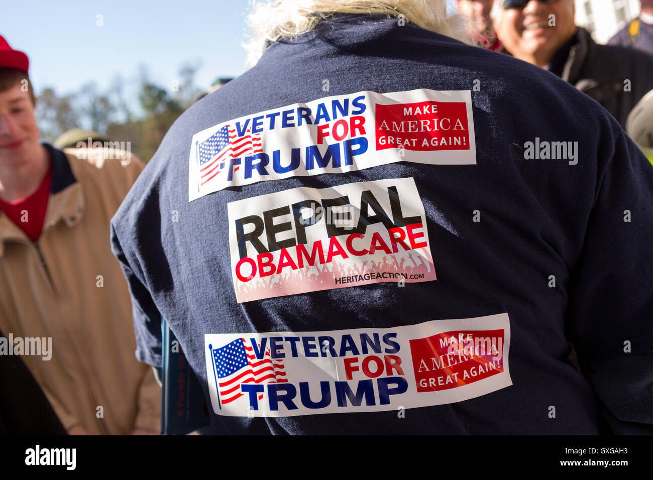 A construction worker wears Billionaire and GOP presidential candidate Donald Trump stickers over his body as he arrives for a rally February 19, 2016 in Myrtle Beach, South Carolina. The Republican primary vote in South Carolina takes place on Saturday, February 20th. Stock Photo