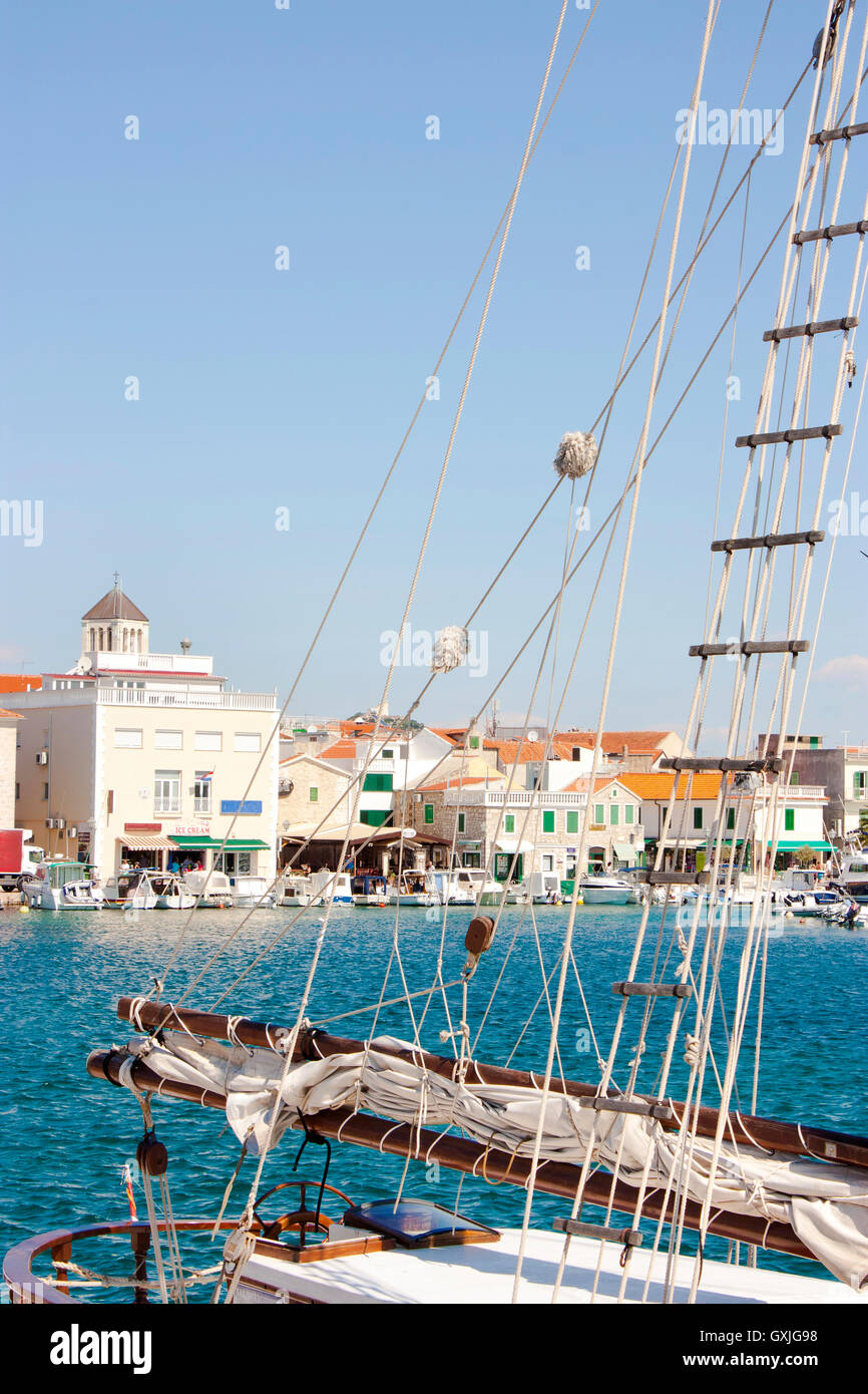 Old town of Vodice, Croatia, seen through rigging  and ropes of a sailing boat Stock Photo