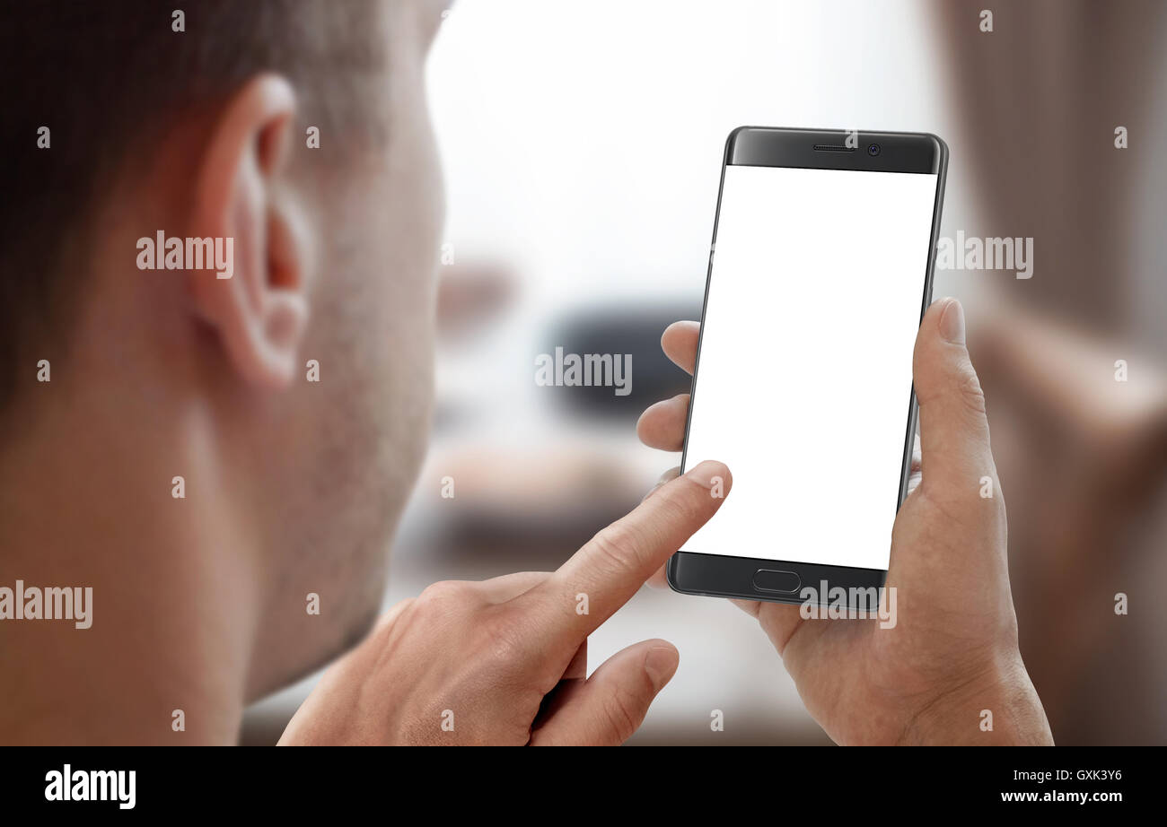Man hold smartphone in room interior. Left hand touch isolated display for mockup. Stock Photo