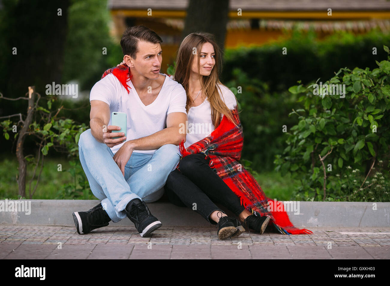 Beautiful young couple relaxing in the park Stock Photo - Alamy