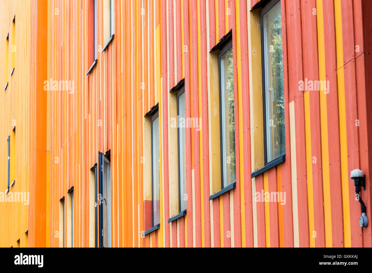 Building painted with yellow, orange and red paint gives a pleasant feeling. Stock Photo