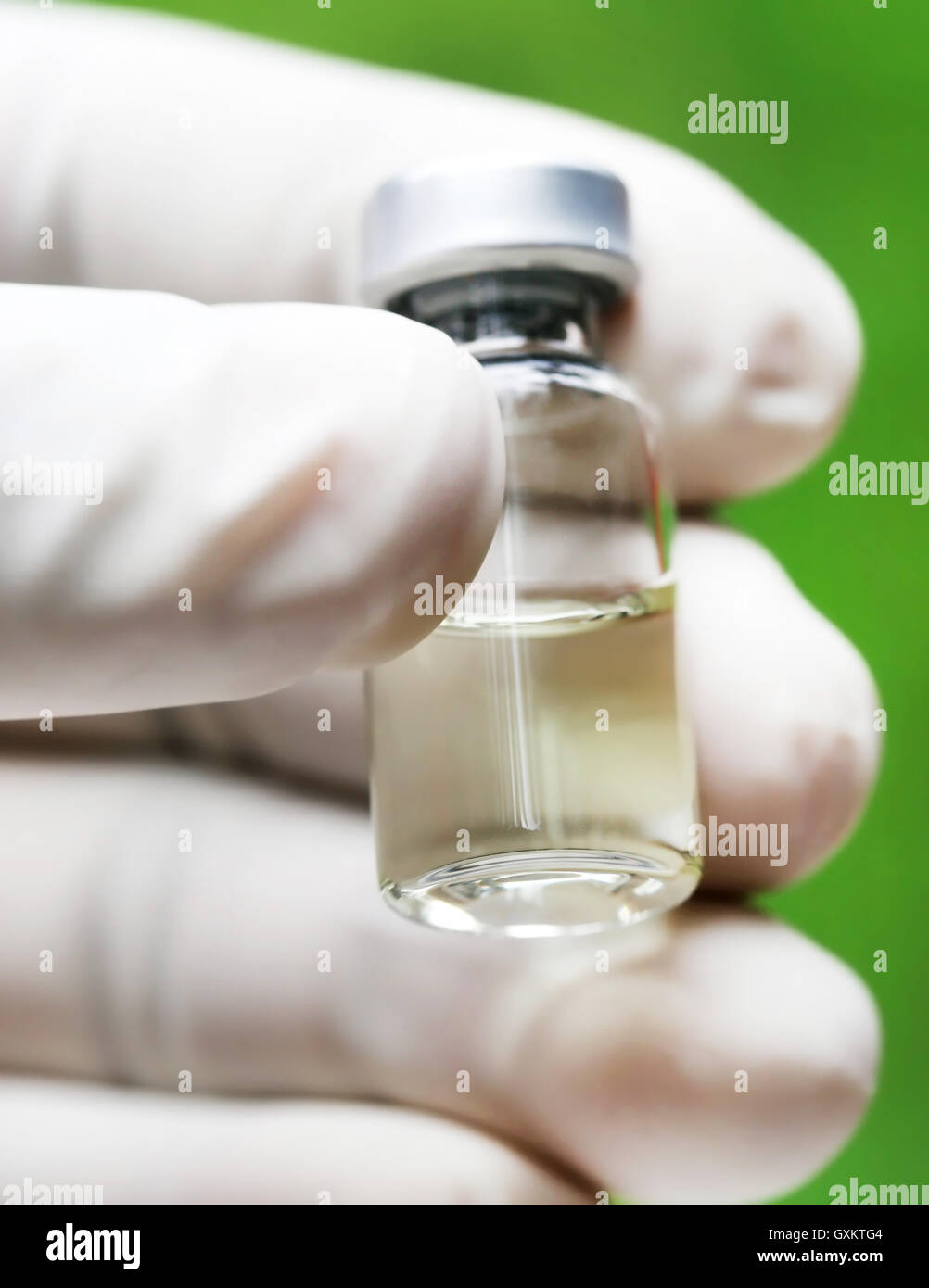 Closeup of a vial holding by hand Stock Photo