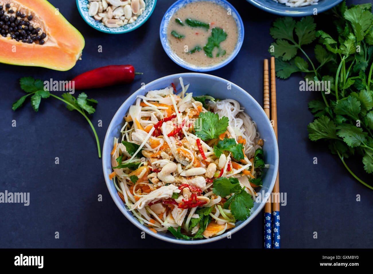 Poached chicken, cabbage and papaya salad with rice noodles and coriander Stock Photo Alamy