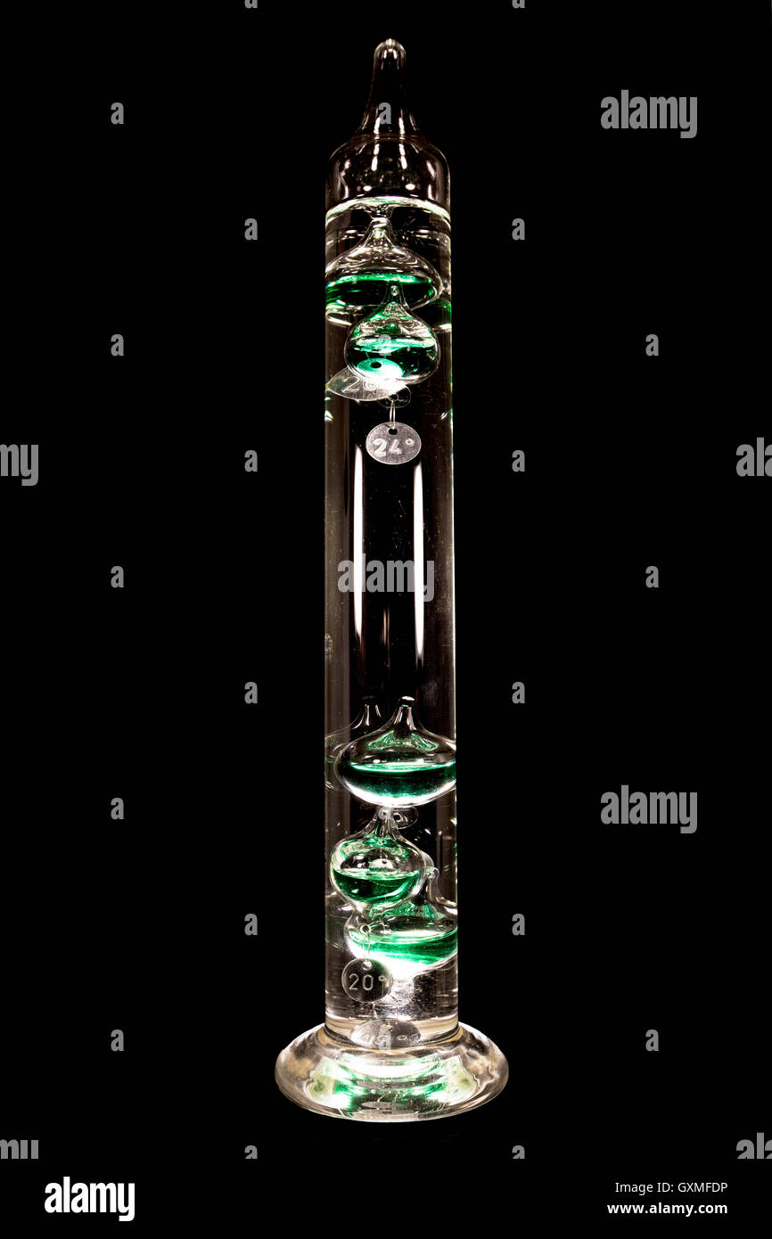 Galileo thermometer or Galilean thermometer, glass cylinder, several glass vessels of varying densities Stock Photo