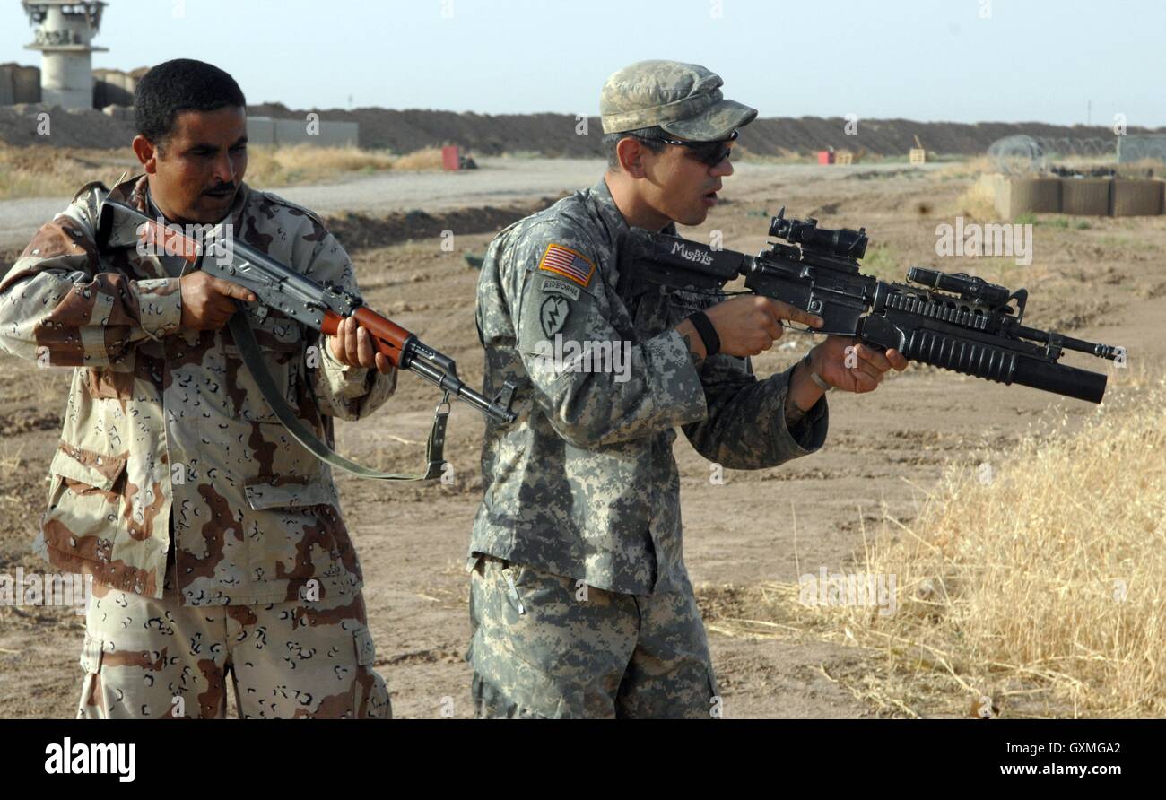 U.S. Army soldier practices dismounted movements with an Iraqi Army soldier in preparation for an upcoming Operation Iraqi Freedom joint operation at Forward Operating Base McHenry June 6, 2007 near Hawija, Iraq. Stock Photo