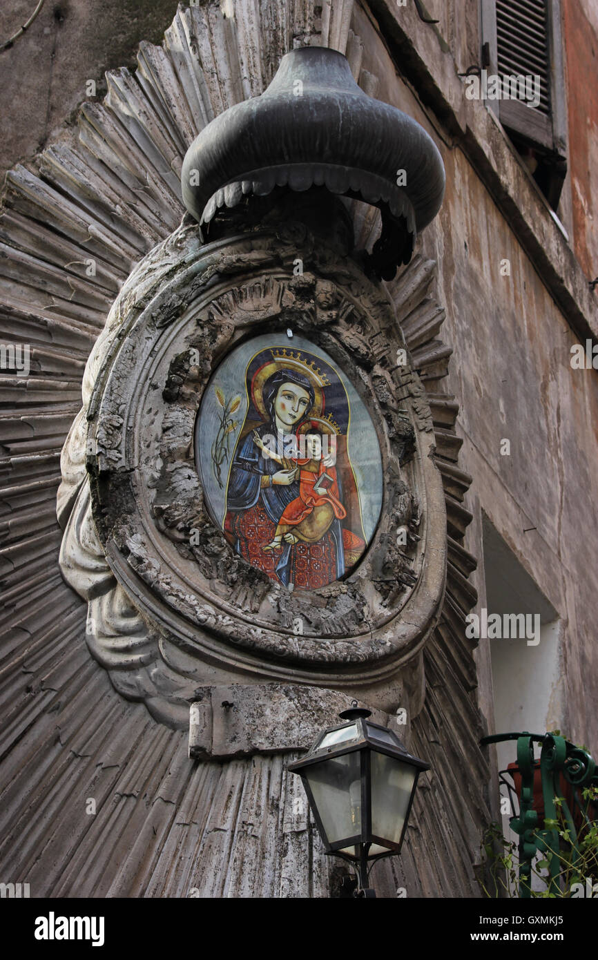 corner shrine, interesting religious decoration on the side of a building portraying the Virgin Mary Madonna and Jesus, Tivoli, Italy Stock Photo