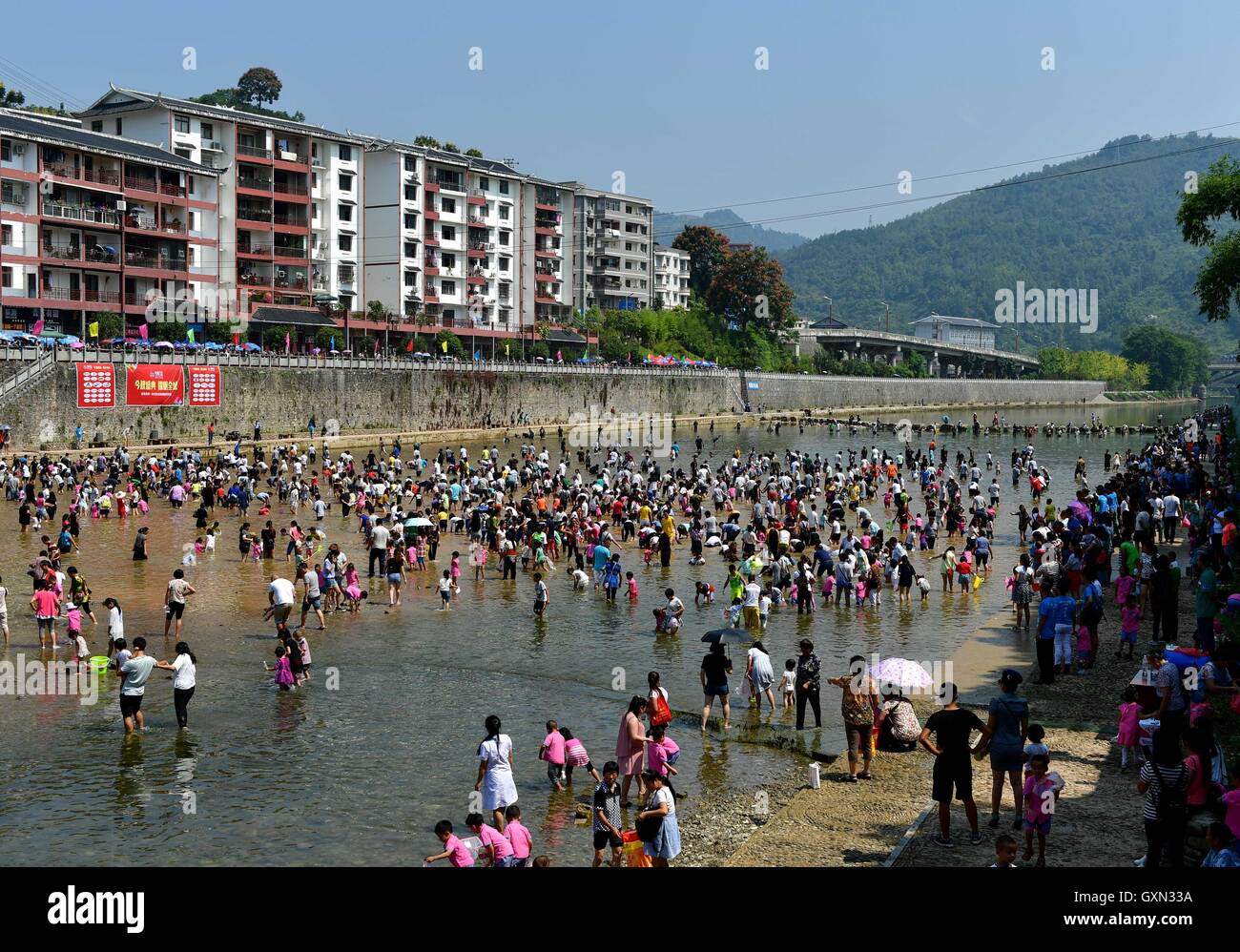 (160916) -- ENSHI, Sept. 16, 2016 (Xinhua) -- Local people gather to catch fish by hands in a river to celebrate a good harvest in Xuanen County, central China's Hubei Province, Sept. 16, 2016. (Xinhua/Song Wen) (cxy) Stock Photo