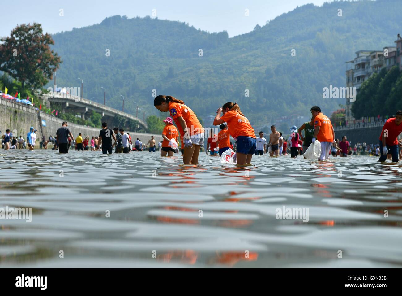 (160916) -- ENSHI, Sept. 16, 2016 (Xinhua) -- Local people catch fish by hands in a river to celebrate a good harvest in Xuanen County, central China's Hubei Province, Sept. 16, 2016. (Xinhua/Song Wen) (cxy) Stock Photo