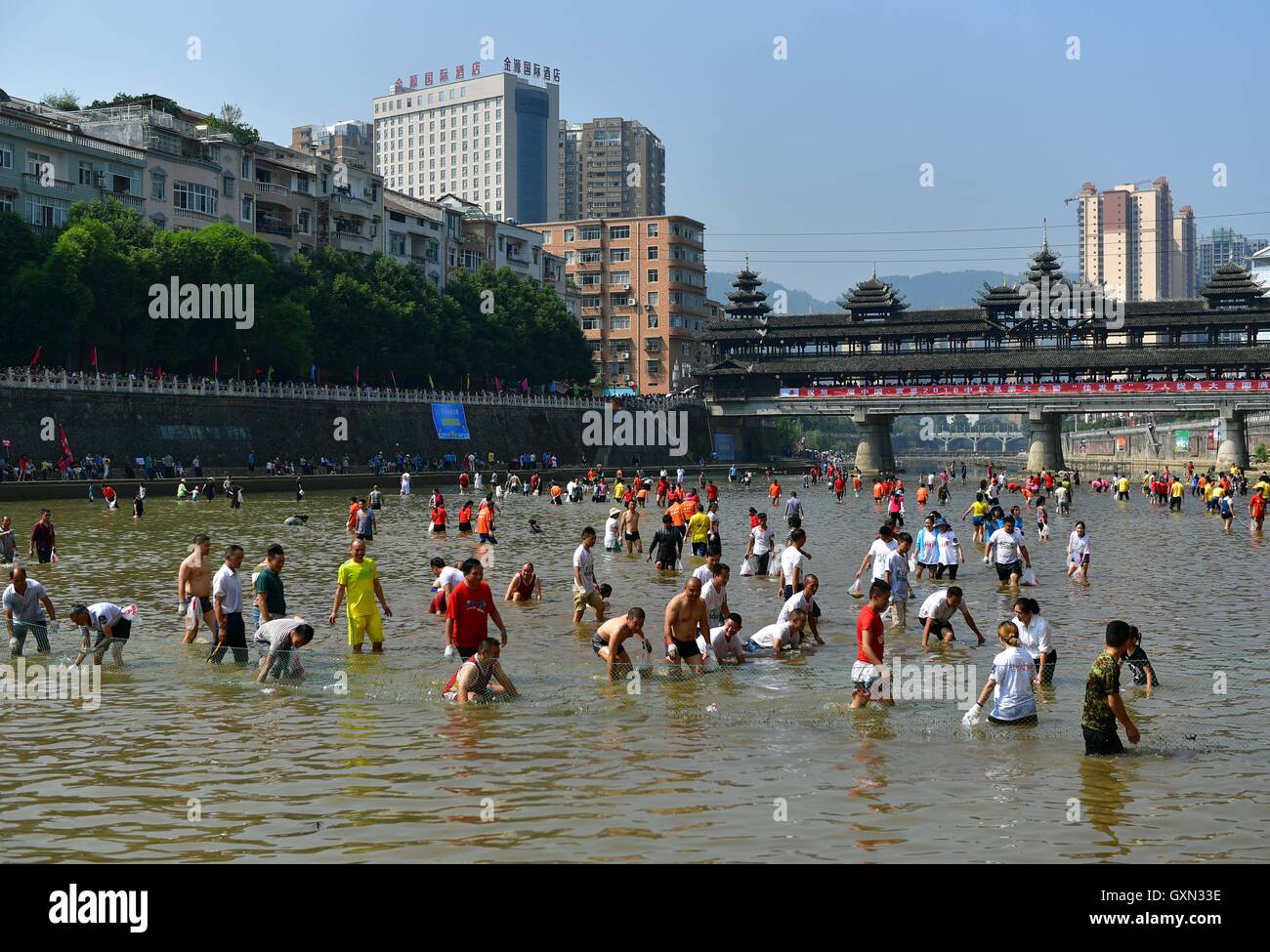 (160916) -- ENSHI, Sept. 16, 2016 (Xinhua) -- Local people gather to catch fish by hands in a river to celebrate a good harvest in Xuanen County, central China's Hubei Province, Sept. 16, 2016. (Xinhua/Song Wen) (cxy) Stock Photo