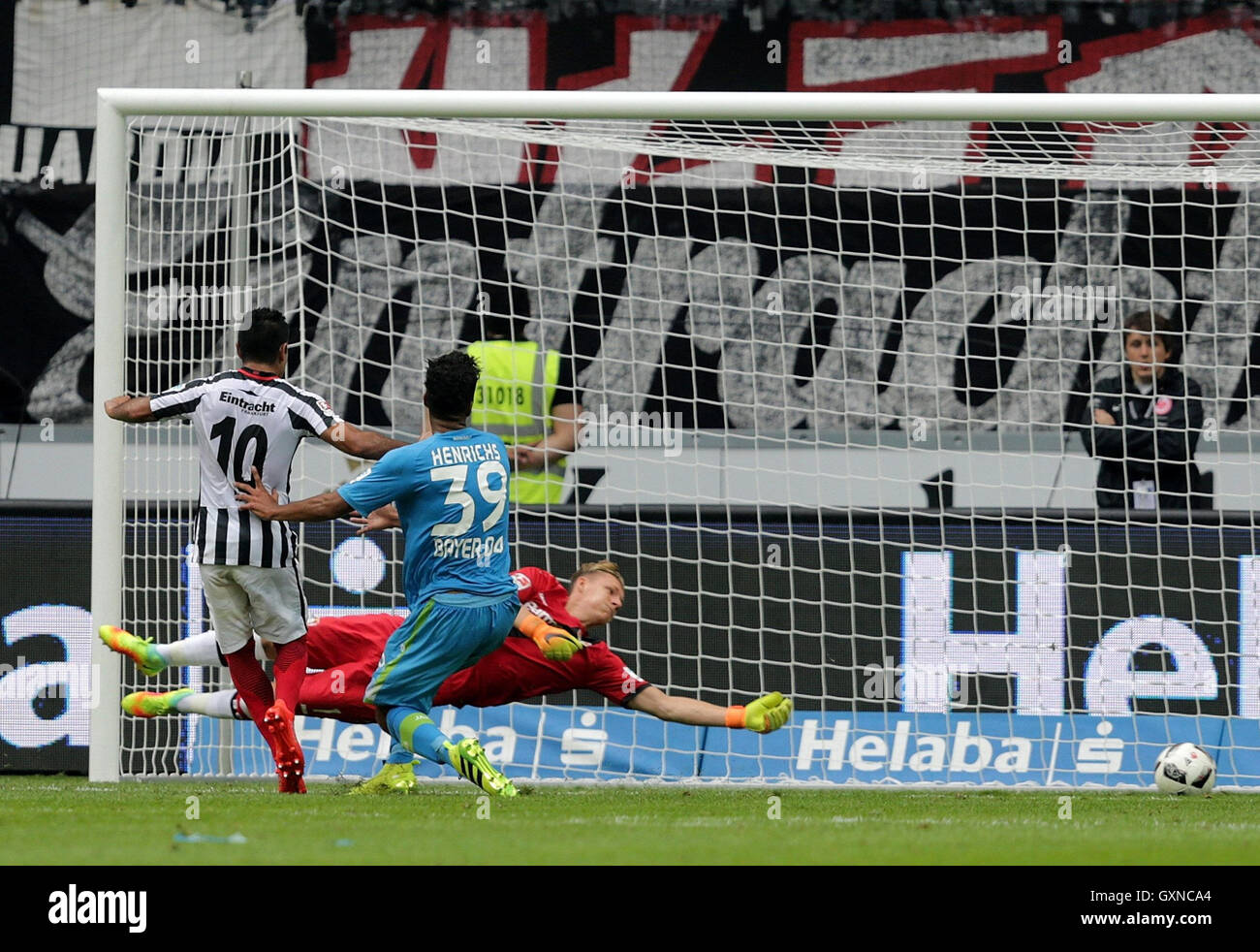 Frankfurt's Marco Fabian (L) scores the 2-1 goal against Leverkusen's goalkeeper Bernd Leno (r) and Benjamin Henrichs during the German Bundesliga soccer match between Eintracht Frankfurt and Bayer Leverkusen in the Commerzbank Arena in Frankfurt am Main, Germany, 17 September 2016. Photo: HASAN BRATIC/dpa (EMBARGO CONDITIONS - ATTENTION - Due to the accreditation guidelines, the DFL only permits the publication and utilisation of up to 15 pictures per match on the internet and in online media during the match) Stock Photo