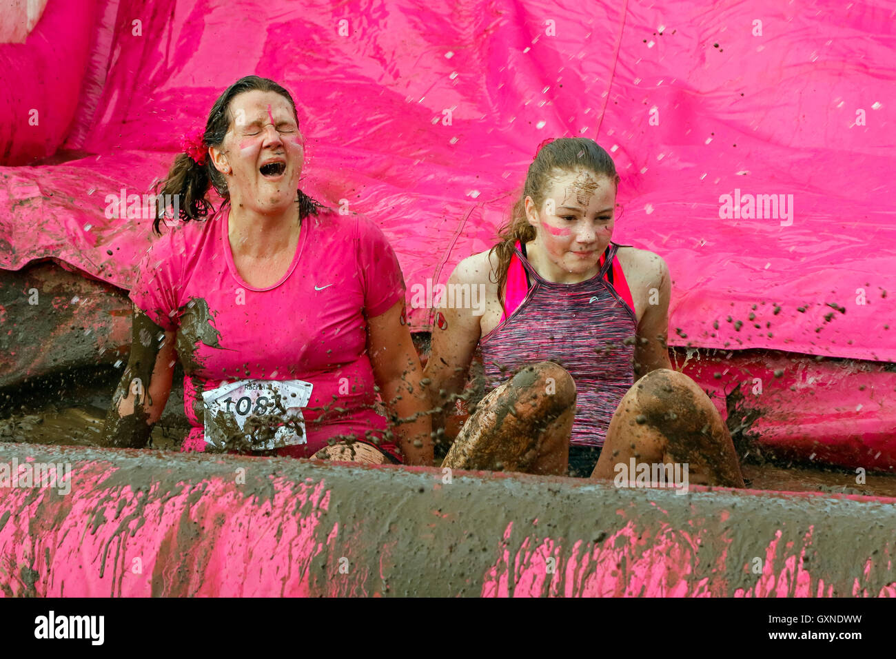 Glasgow, Scotland, UK. 17th September, 2016. Thousands of women took part in the Bellahouston Park Pretty Muddy 5k across obstacles, through pipes, across fields on spacehoppers and over mud slides to raise awareness and funds for Cancer Research UK. Many ran in teams and with friends and all finished laughing and very, very muddy! Credit:  Findlay/Alamy Live News Stock Photo