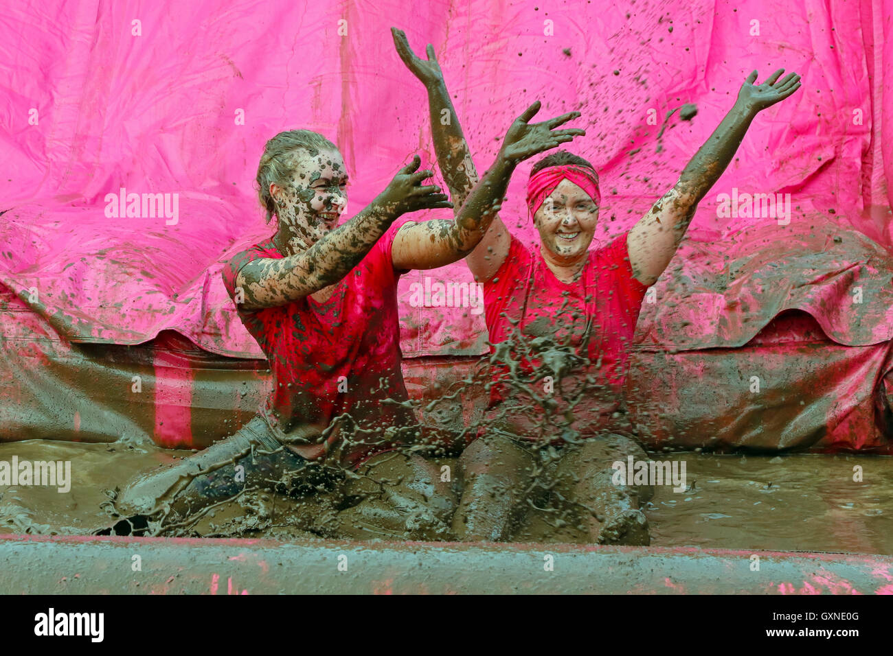 Glasgow, Scotland, UK. 17th September, 2016. Thousands of women took part in the Bellahouston Park Pretty Muddy 5k across obstacles, through pipes, across fields on spacehoppers and over mud slides to raise awareness and funds for Cancer Research UK. Many ran in teams and with friends and all finished laughing and very, very muddy! Credit:  Findlay/Alamy Live News Stock Photo