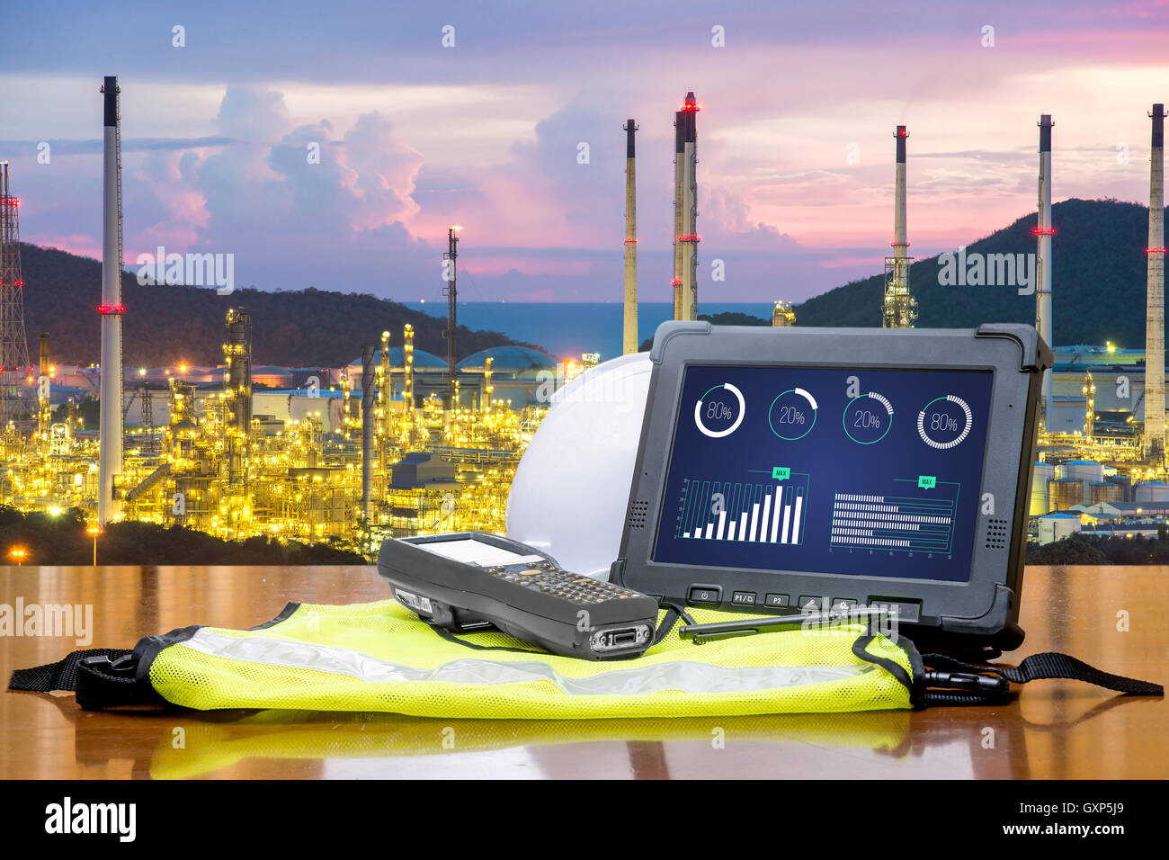 Smart factory - Rugged computers tablet in front of oil refinery industry. Stock Photo
