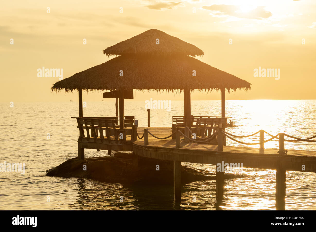 Summer, Travel, Vacation and Holiday concept - Wooden pier between sunset in Phuket, Thailand. Stock Photo