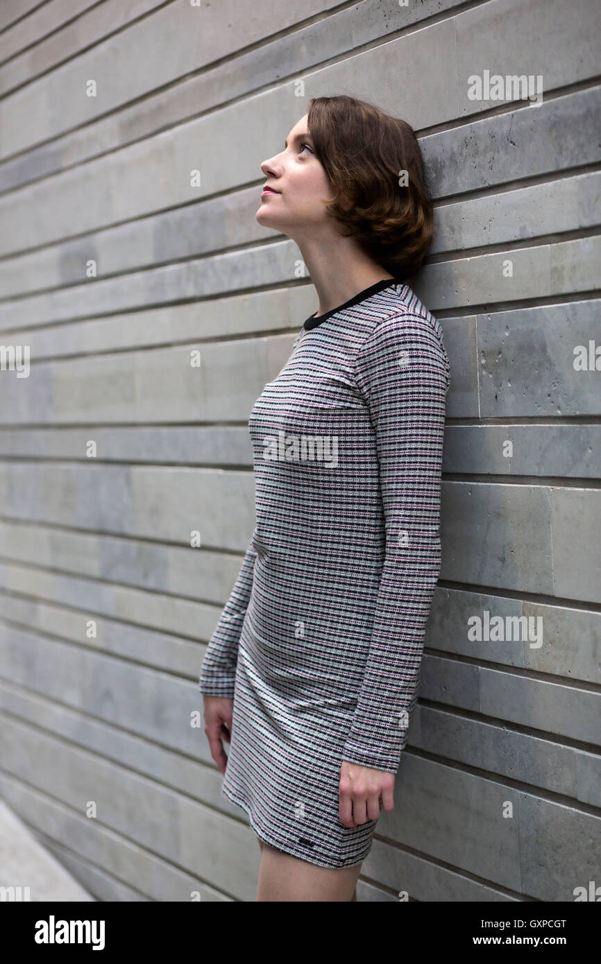 Woman at dress look up at lamplight Stock Photo - Alamy