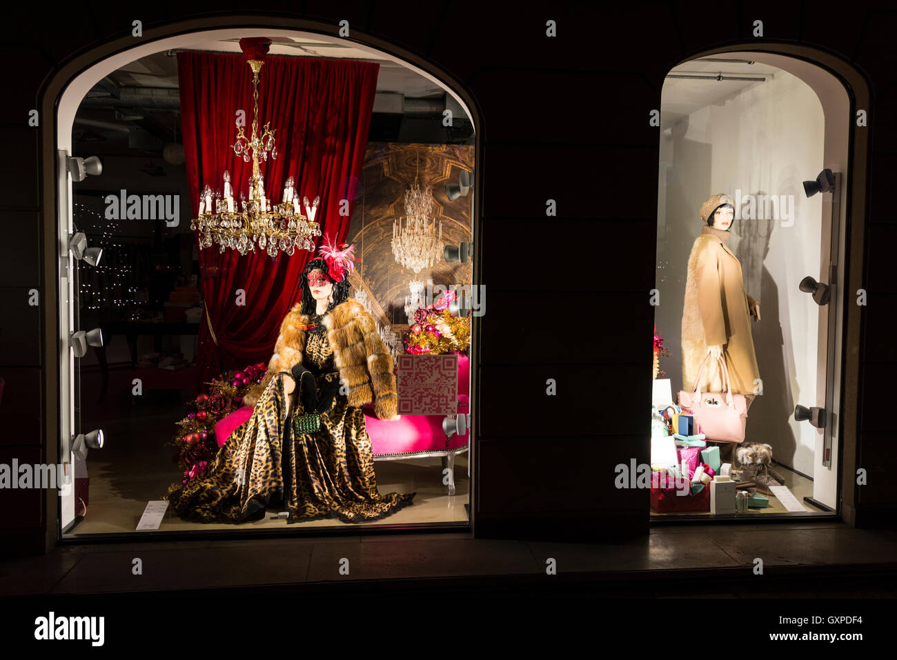 A ladies clothes shop window display with Christmas decorations as part