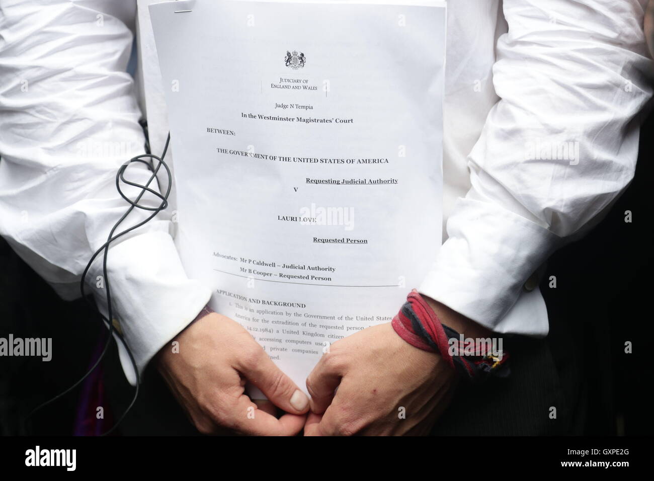 Lauri Love, who is accused of hacking into US Government computers, holds court papers outside Westminster Magistrates' Court, London, where a judge ruled that he can be extradited to the US from Britain to stand trial. Stock Photo