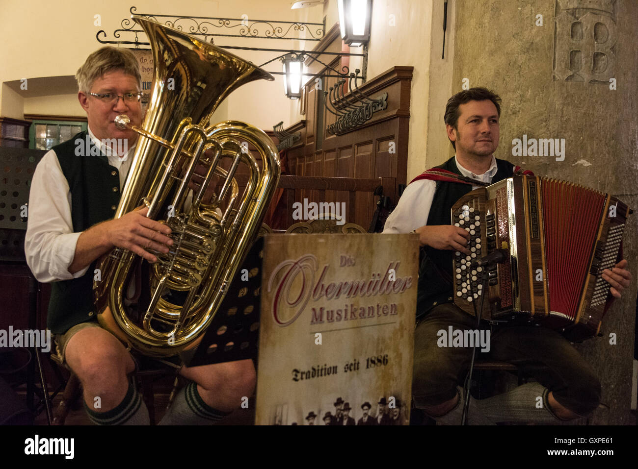 Live Bavarian music performed by members wearing Lederhosen, (traditional Bavarian short trousers), at the famous Hofbräuhaus be Stock Photo