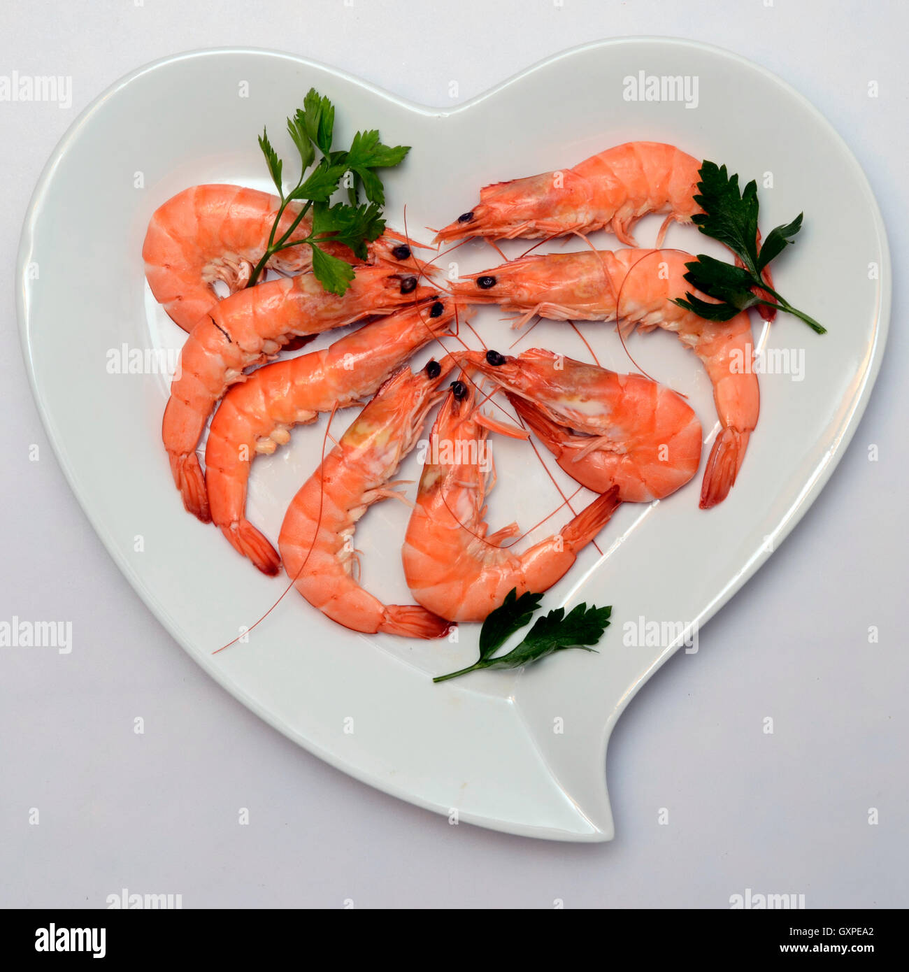 Some Shrimp or pink prawn in white heart shaped plate Stock Photo Alamy