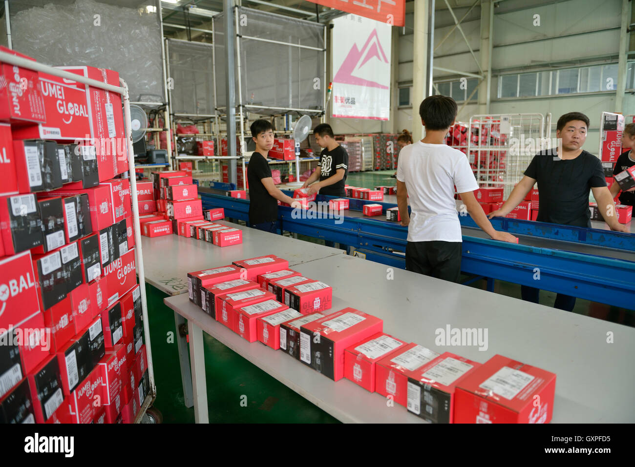 Staff checks goods shopped from overseas through Jumei Global online channel during delivery at EHL International Logistics Stock Photo