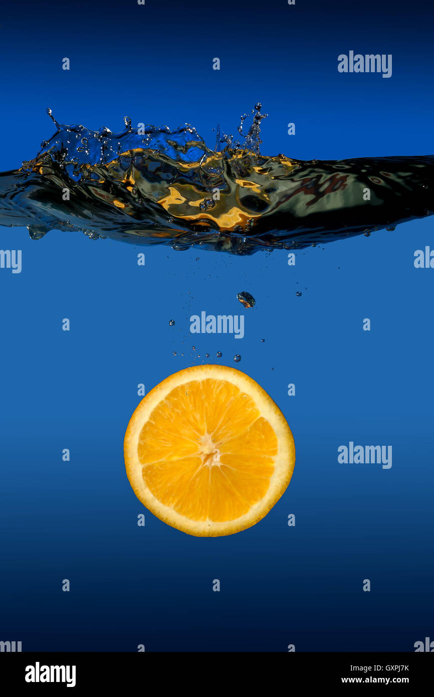 Exotic tropical fruit orange floats under water Stock Photo Alamy