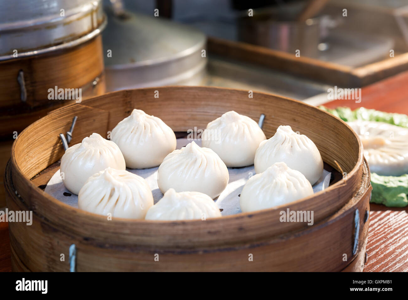 Chinese food steamed bun in bamboo basket in food market, Shanghai, China. Stock Photo