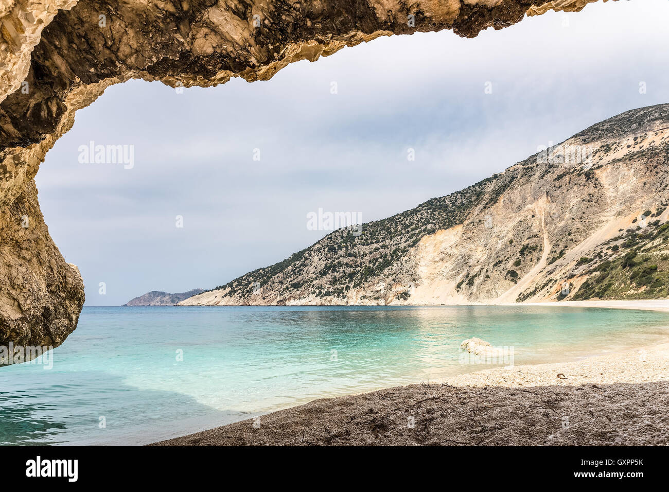 Cave outlook on cove with  sea mountain and gravel beach Stock Photo