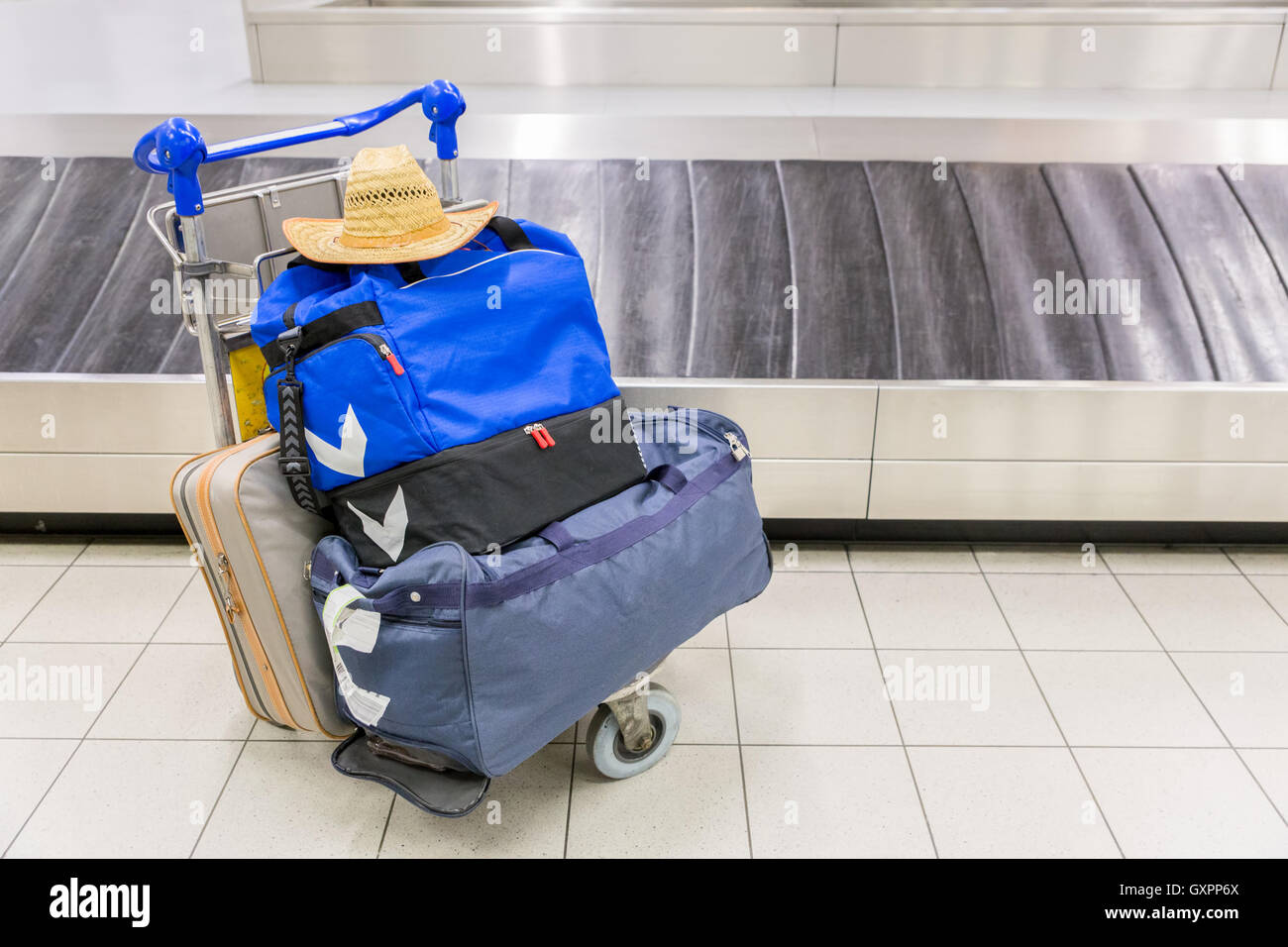 Luggage and travel bags near baggage band at airport Stock Photo