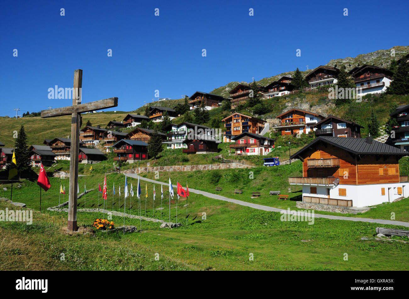 Church cross and Bettmeralp village in the Swiss Alps, Valais ...