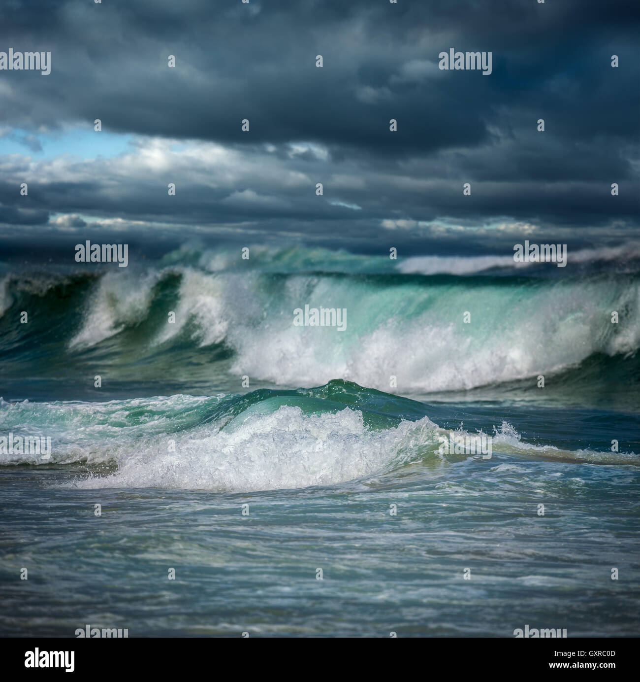 Dangerous stormy weather - dramatic dark clouds and big ocean waves ...