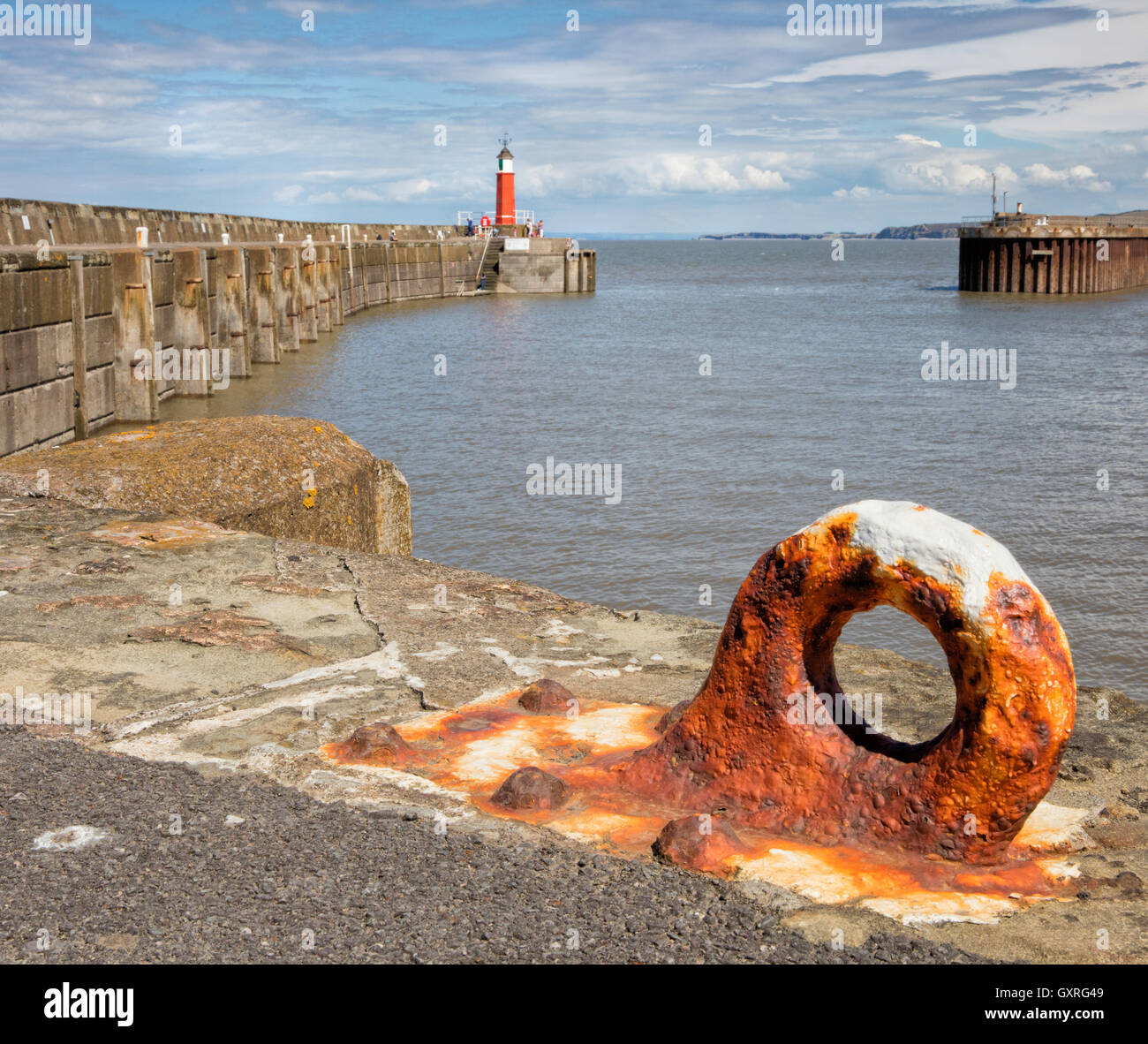 Watchet harbour on the west coast of Somerset UK  with lighthouse and quayside ironwork Stock Photo