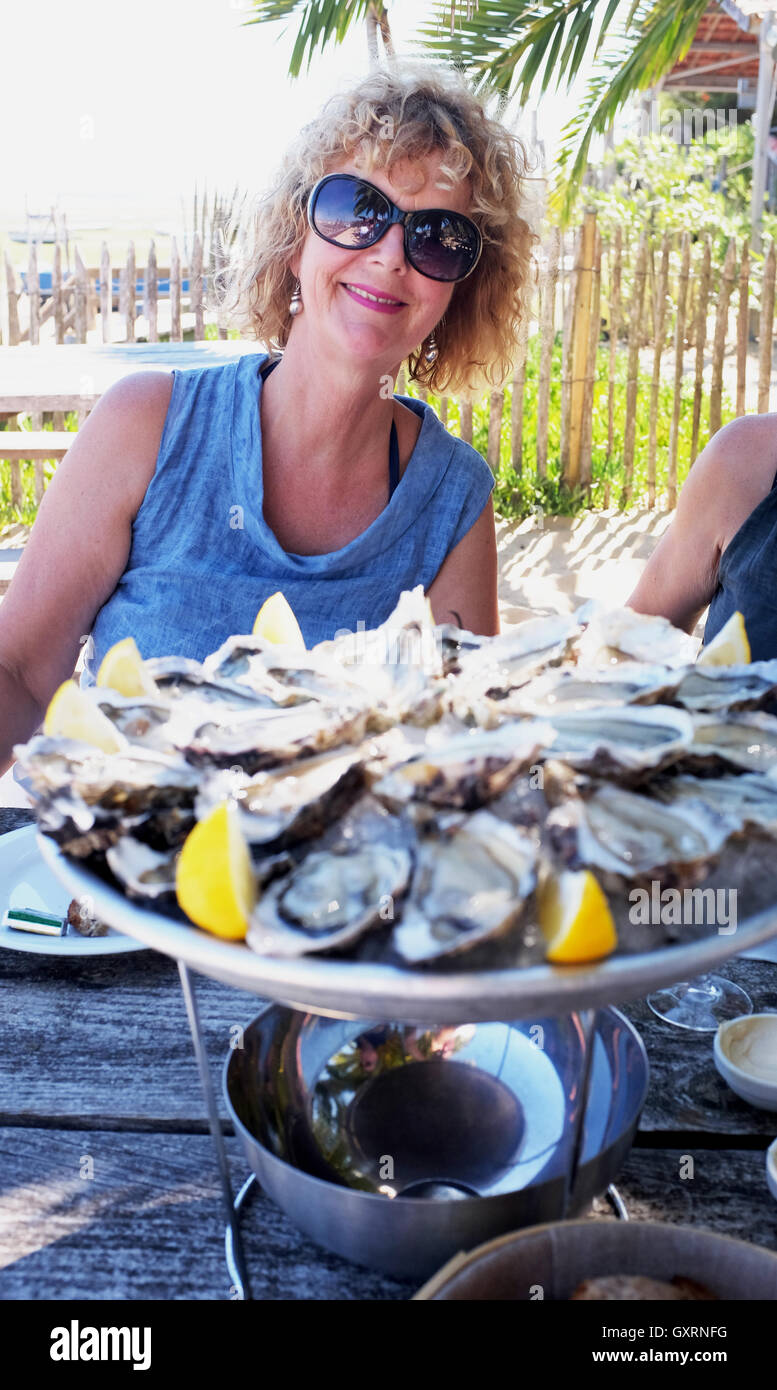 Woman eating oysters hires stock photography and images Alamy