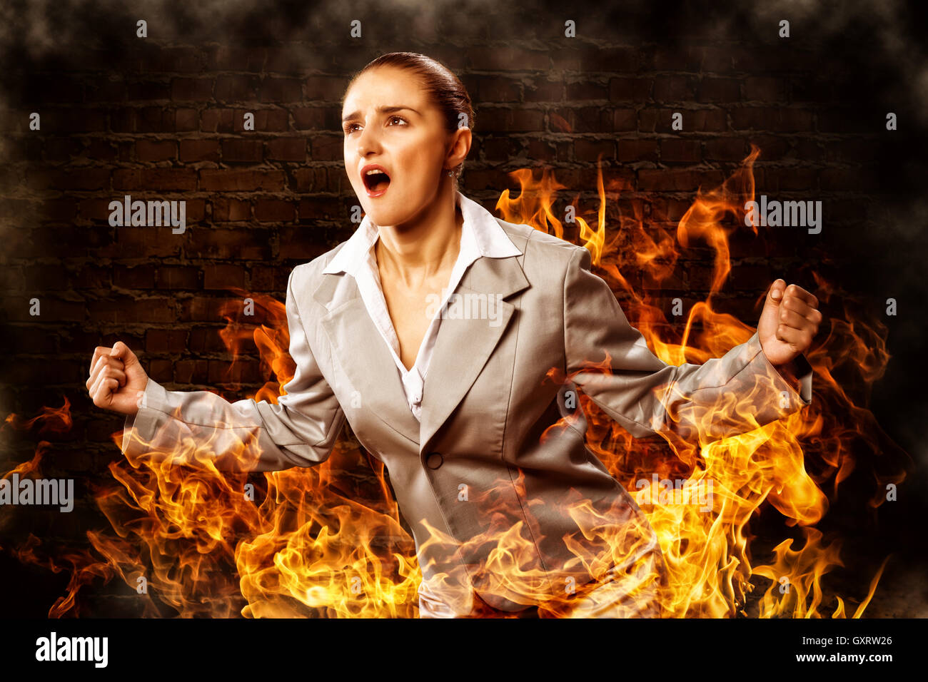 violent woman, surrounded by smoke Stock Photo