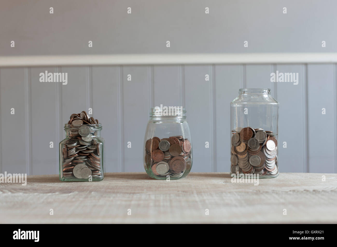 Glass jars with coins Stock Photo