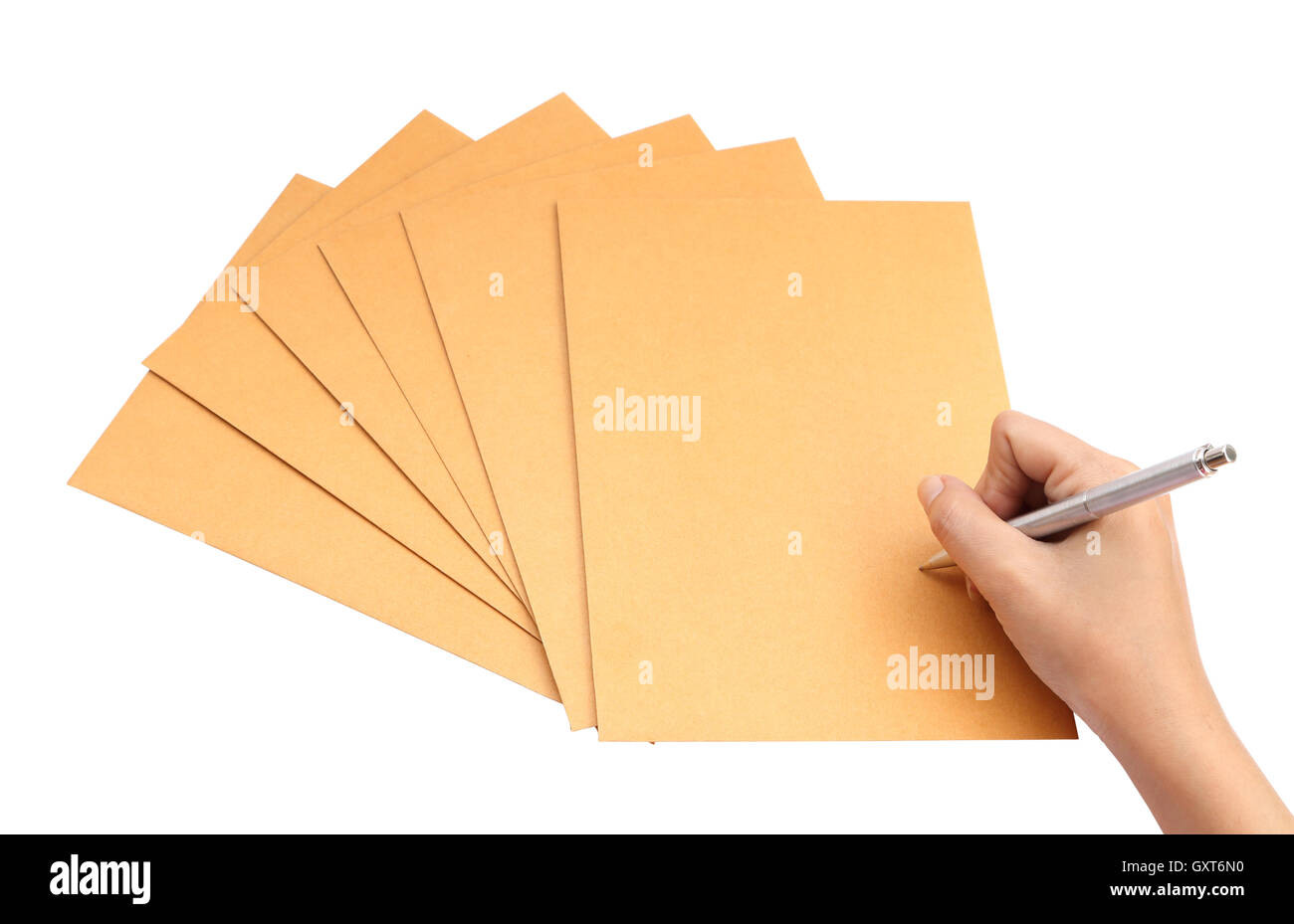 hand with pen writing on the envelope on white background Stock Photo
