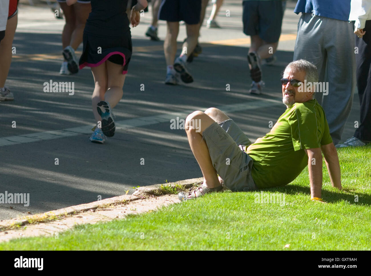 Spectator relaxes during Bolder Boulder Stock Photo