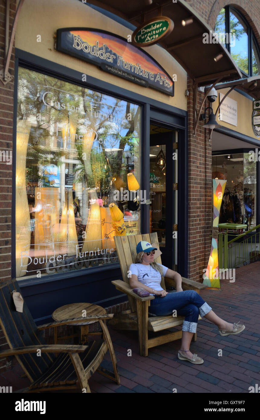 Sarah Wood from Montana relaxes in a chair in front of Boulder Furniture Arts on Pearl St. Stock Photo