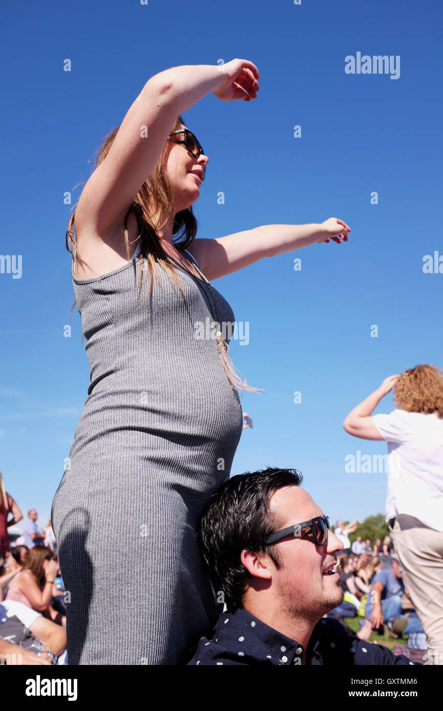 Young pregnant woman enjoying a party at festival in a Day at Hyde Park
