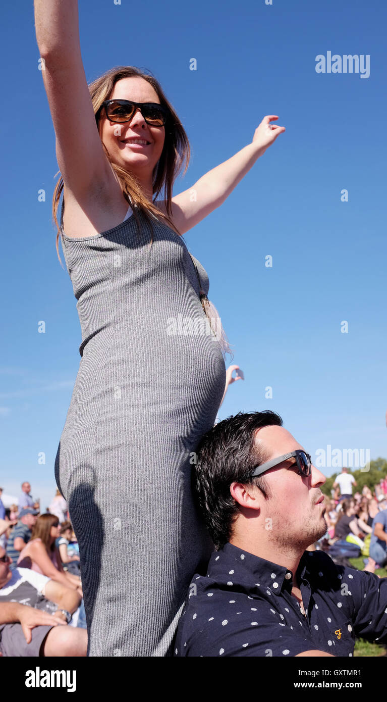 Young pregnant woman enjoying a party at festival in a Day at Hyde Park