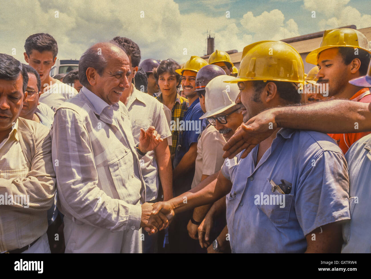 CIUDAD GUAYANA, VENEZUELA - Presidential candidate Carlos Andres Perez campaigning, shaking hands of workers at Ferrominera factory. October 1988 Stock Photo